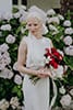 bride standing with her vibrant florals and elegant bridal dress- Nelson Wedding