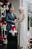 bride and groom slicing their vibrant red wedding cake- Nelson Wedding