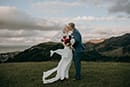 bride and groom kissing while waiting for the sun to set- Nelson Wedding